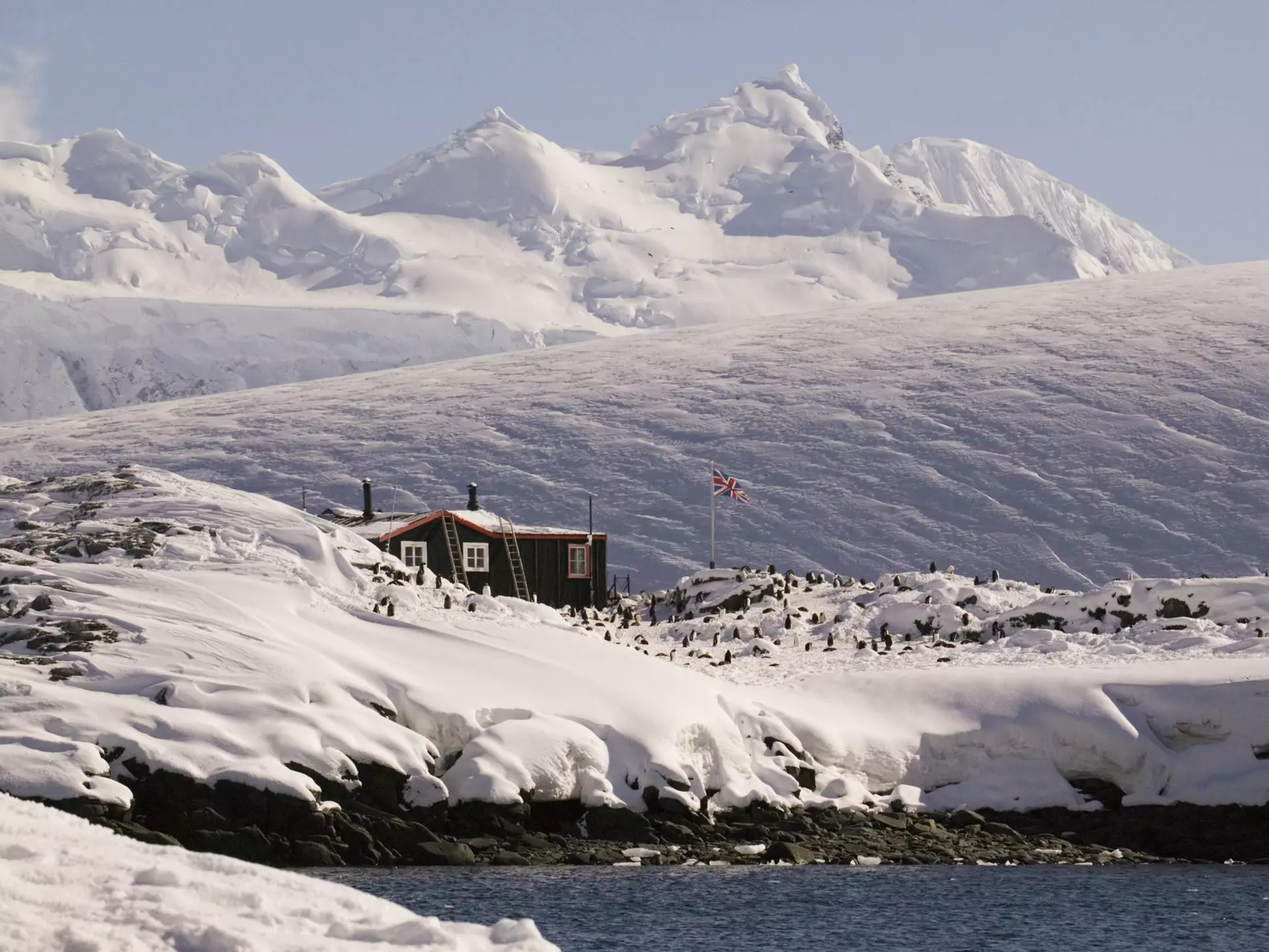 Far away shot of the Antarctic peninsula, Goudier Island, Old British Base at Port Lockroy, Bransfield House