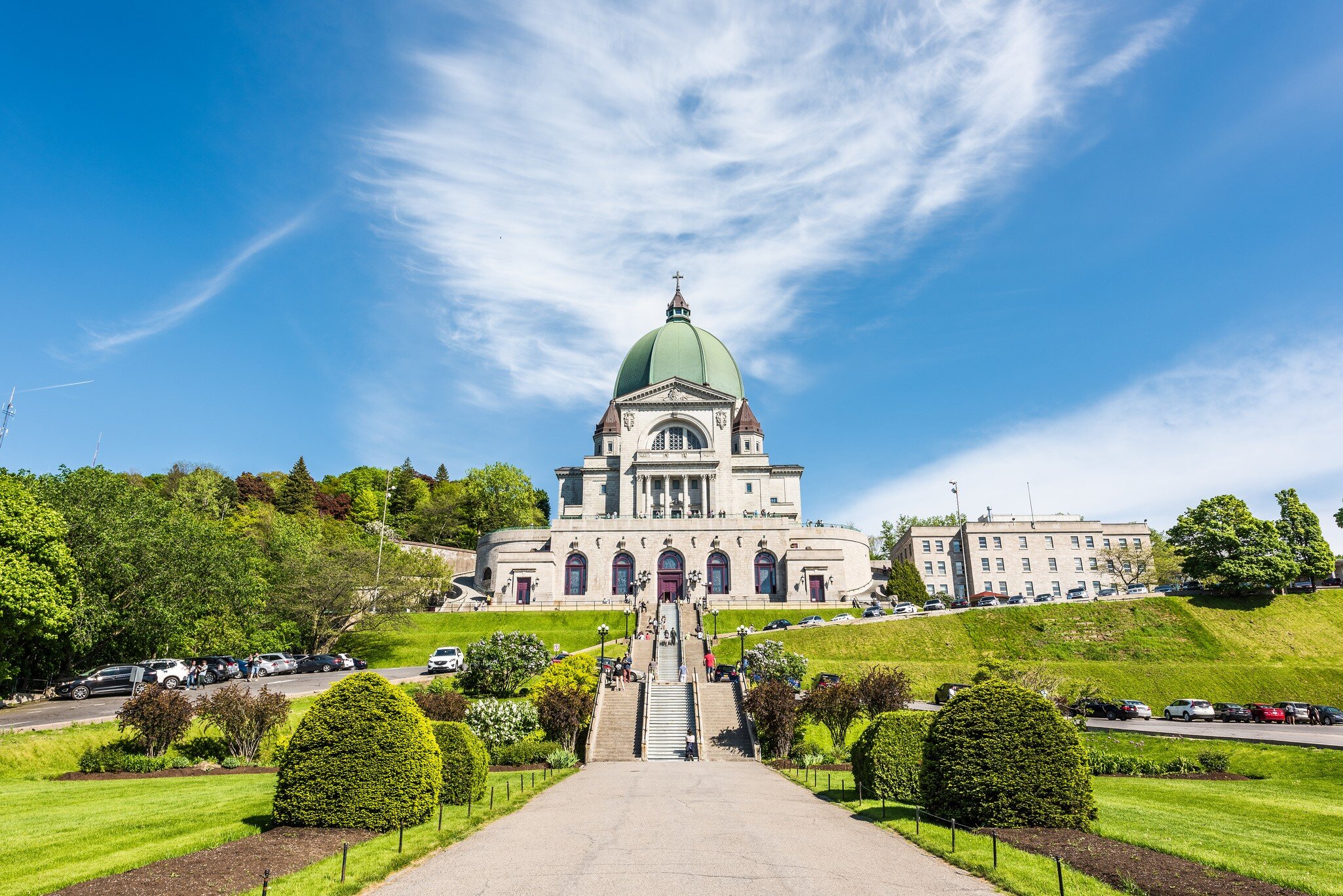 May 28, 2017: St Joseph's Oratory on Mont Royal with a woman praying on steps.
