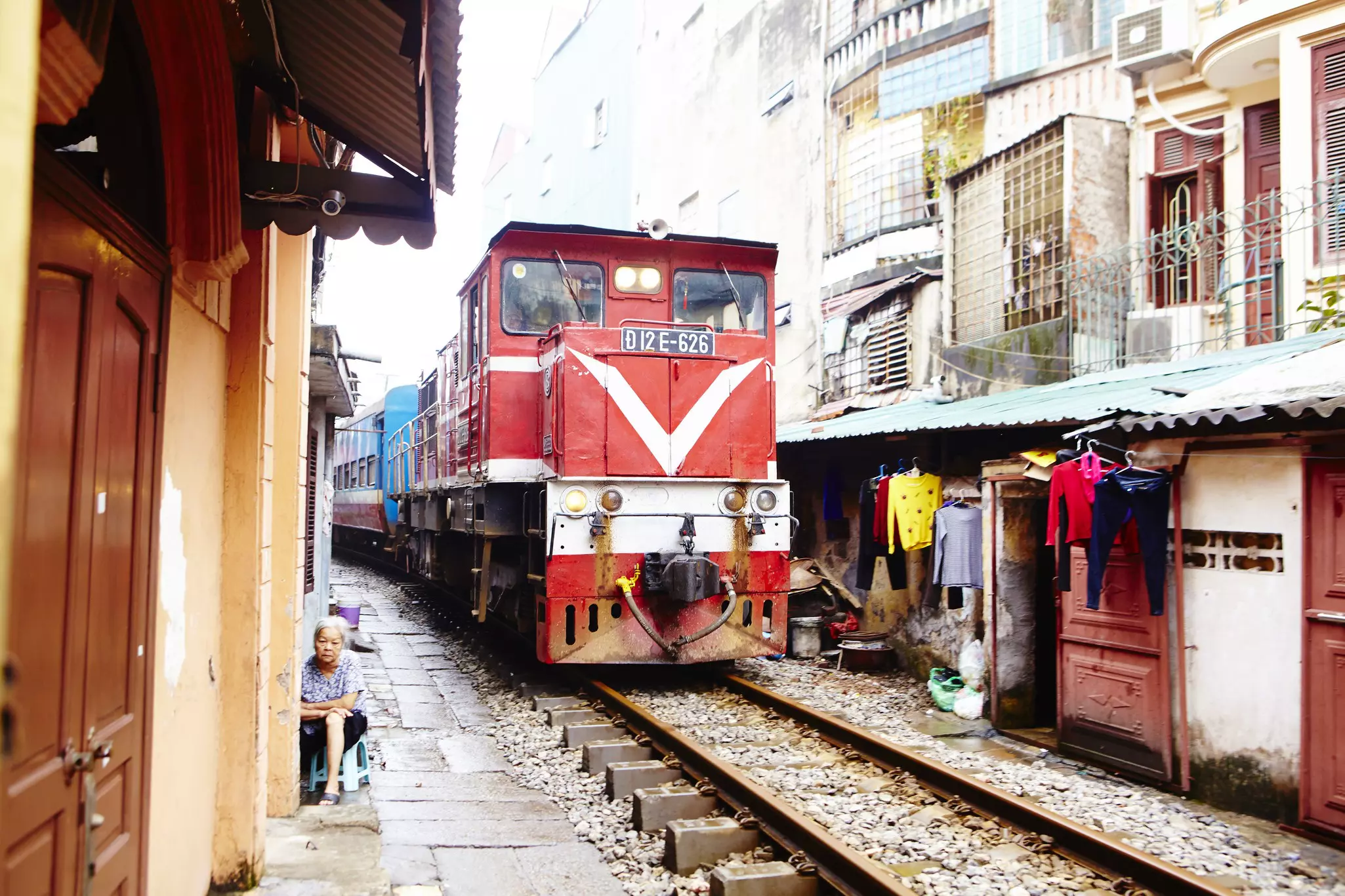 The Reunification Express edging past houses in the backstreets of Hanoi’s Old Quarter