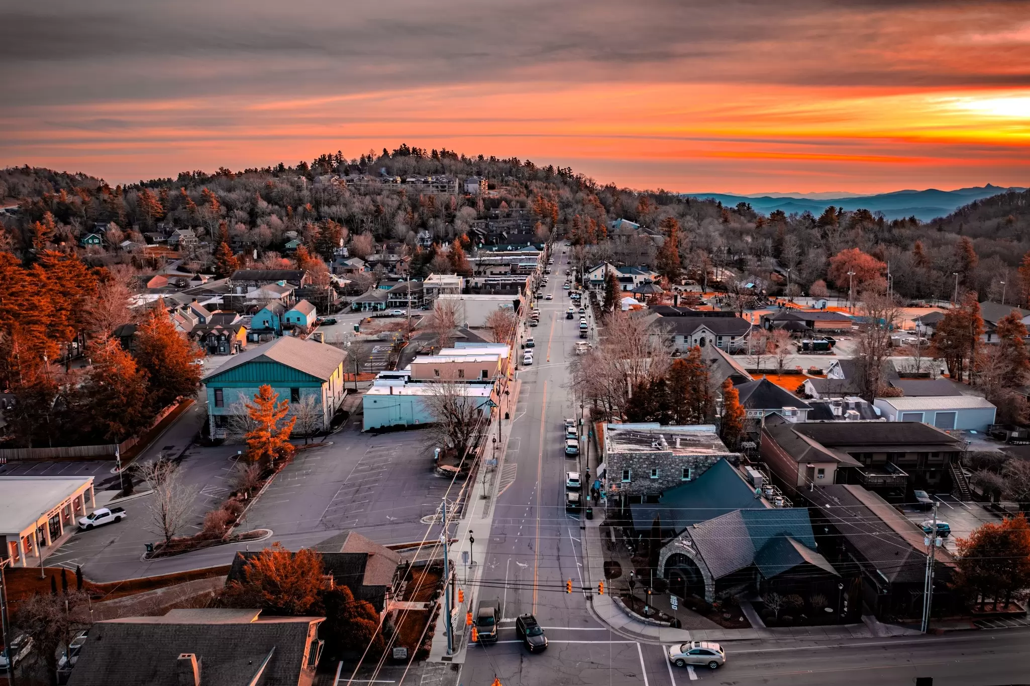 An aerial view of Main St in a small town in the mountains with beautiful sunset light, Blowing Rock, North Carolina
