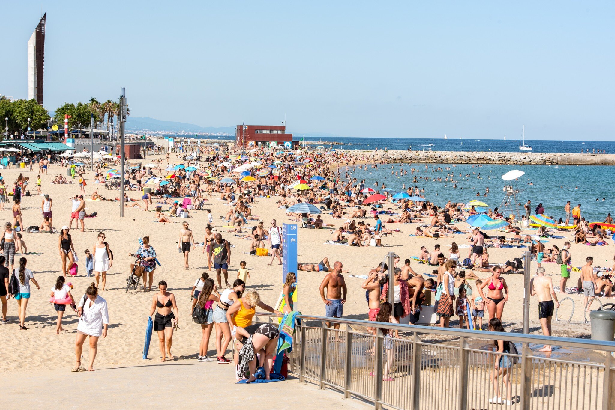 BARCELONA - JUNE 26, 2020: Platja de la Nova Icària beach with people in summer after COVID 19 on June 26, 2020 in Barcelona, Spain.