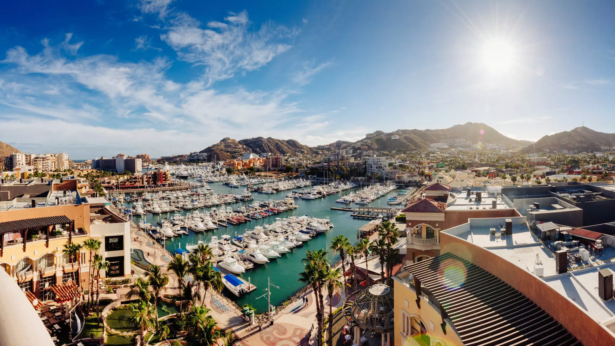 High-angle view of Cabo San Lucas harbour in Mexico.
1141727557
Mexico, Fishing Boat, Latin America, Travel Destinations, Horizontal, Pacific Ocean, Shopping Mall, Sky, Urban Skyline, Sea Of Cortes, Stitched Image, Surf, Copy Space, Sun, Idyllic, Beauty In Nature, Incidental People, Shopping, Baja California Sur, Landscape - Scenery, Sea, Water, Panoramic, Travel, Sunset, Harbor, Cabo San Lucas, Lands End - Cabo San Lucas, Outdoors, High Angle View, Photography, Beach, Lens Flare, Aerial View