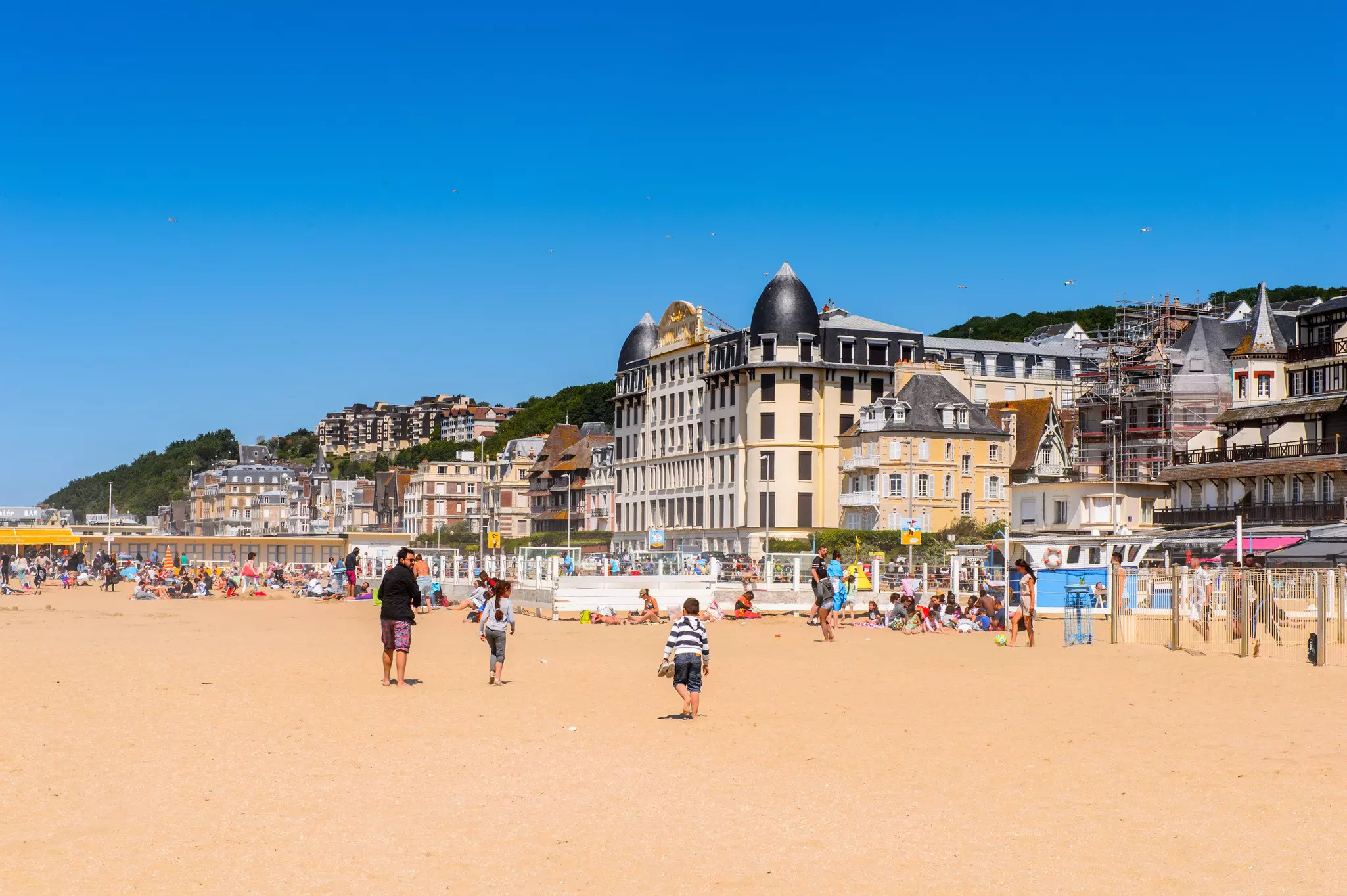 Visitors at the beach on the coast of Trouville.