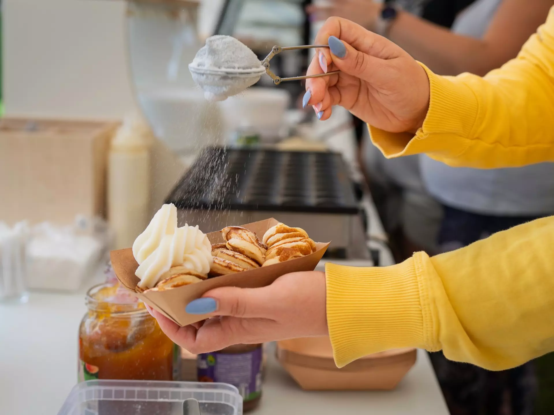 Dutch Mini Pancakes Poffertjes. Fluffy mini pancakes that are served with a mess of powdered sugar and whipped cream. Dutch poffertjes - tiny pancakes- being prepared during street food festival., License Type: media, Download Time: 2025-12-12T11:49:11.000Z, User: pinkjozie64, Editorial: false, purchase_order: 56530 - Guidebooks, job: Global Publishing WIP (for books) , client: amsterdam 14, other: Jo-anne Riddell