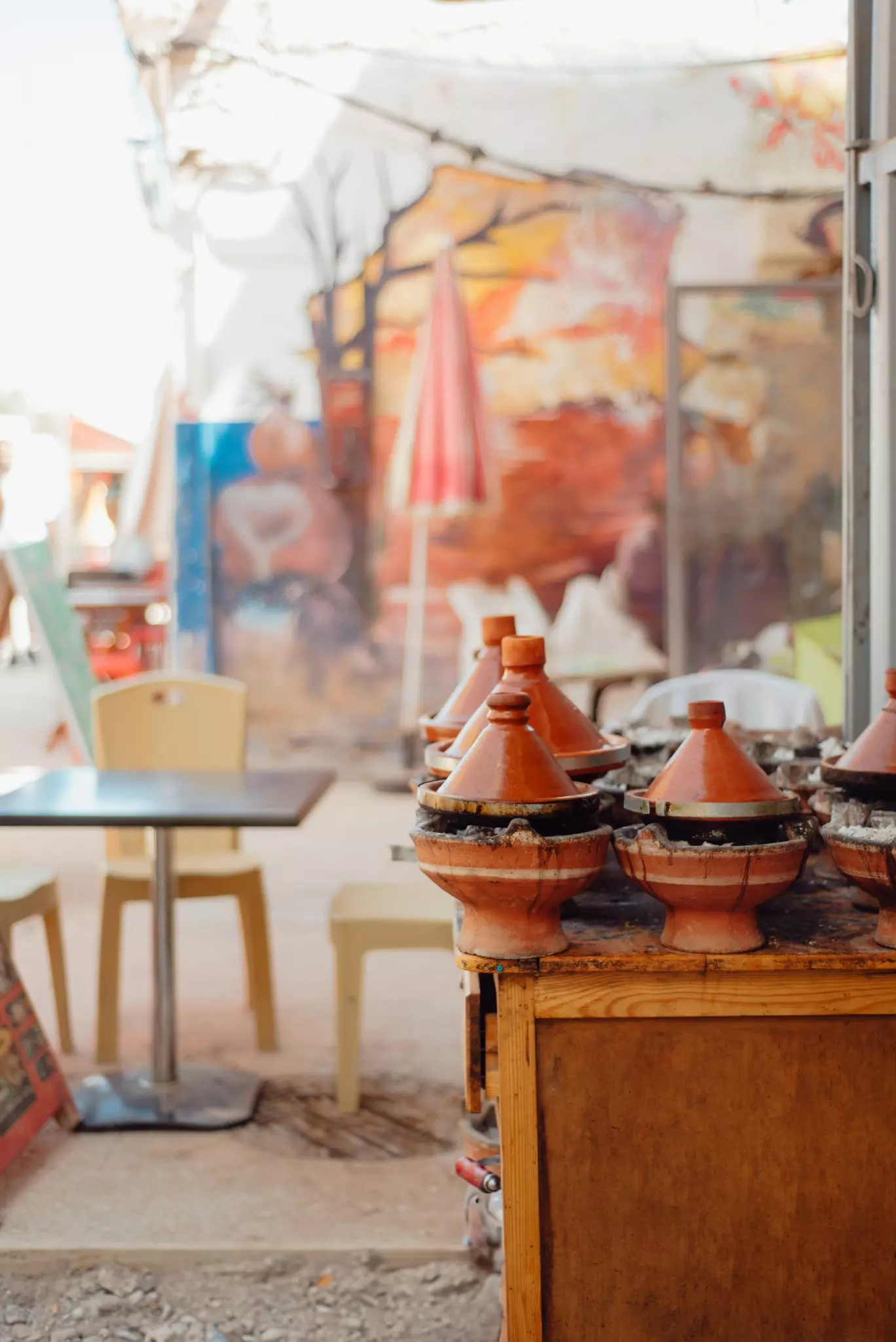 chairs in a street cafe with orange pots