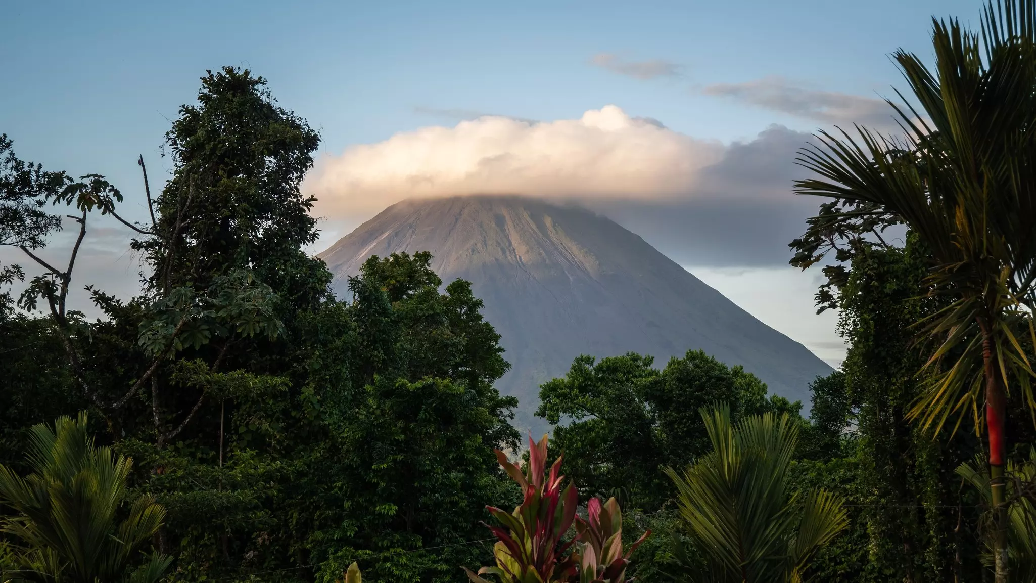 Sunset view of Volcán Arenal and a tropical rainforest near La Fortuna