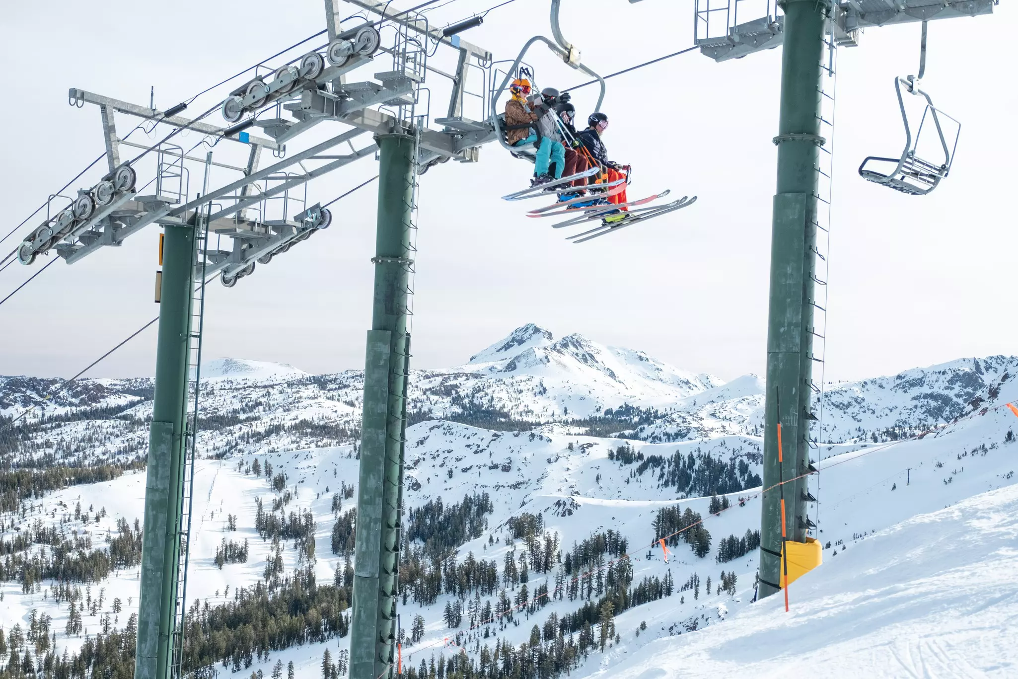 A group of skiers going up a lift.