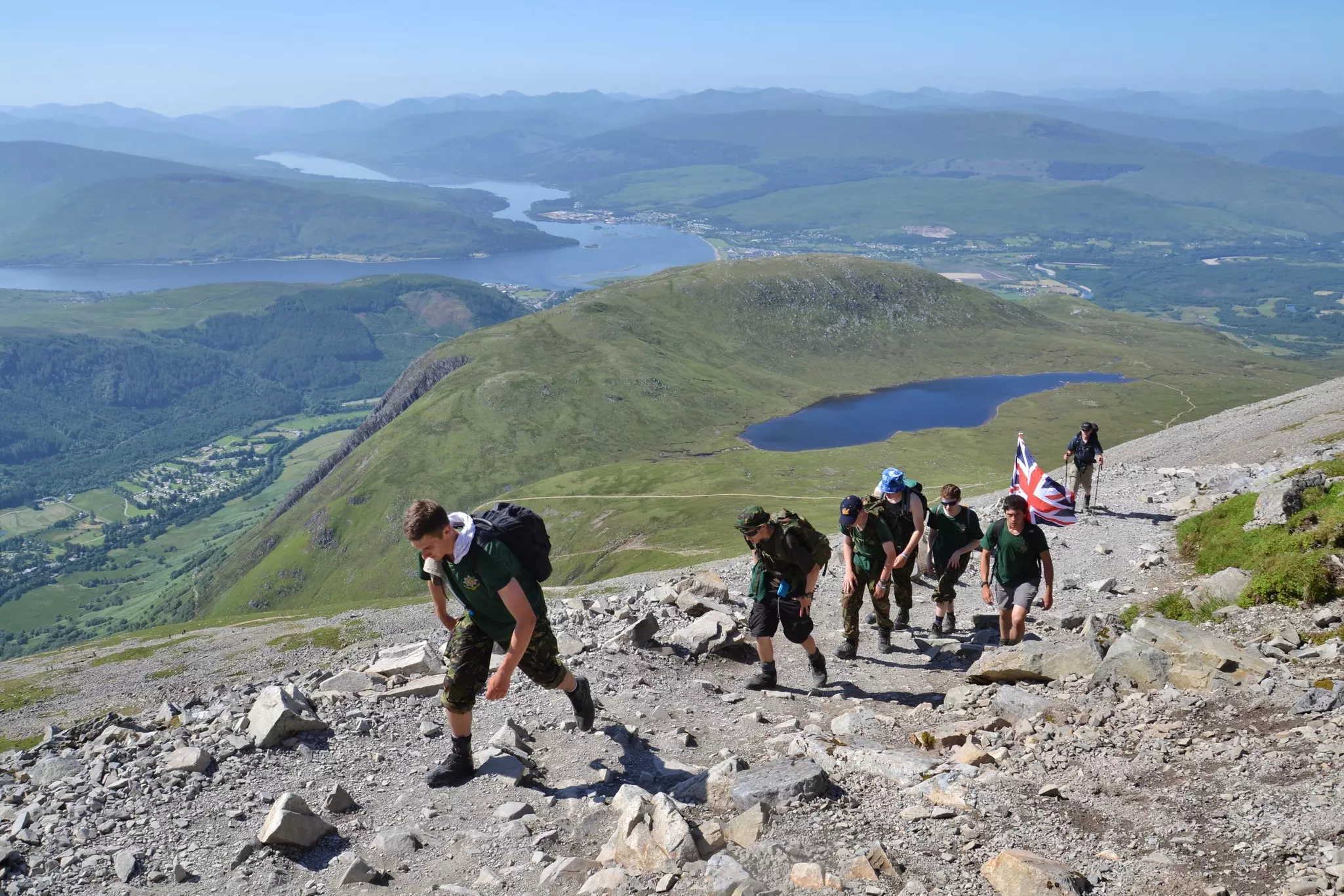 People hiking on the Ben Nevis summit trail near Fort William, Scotland.