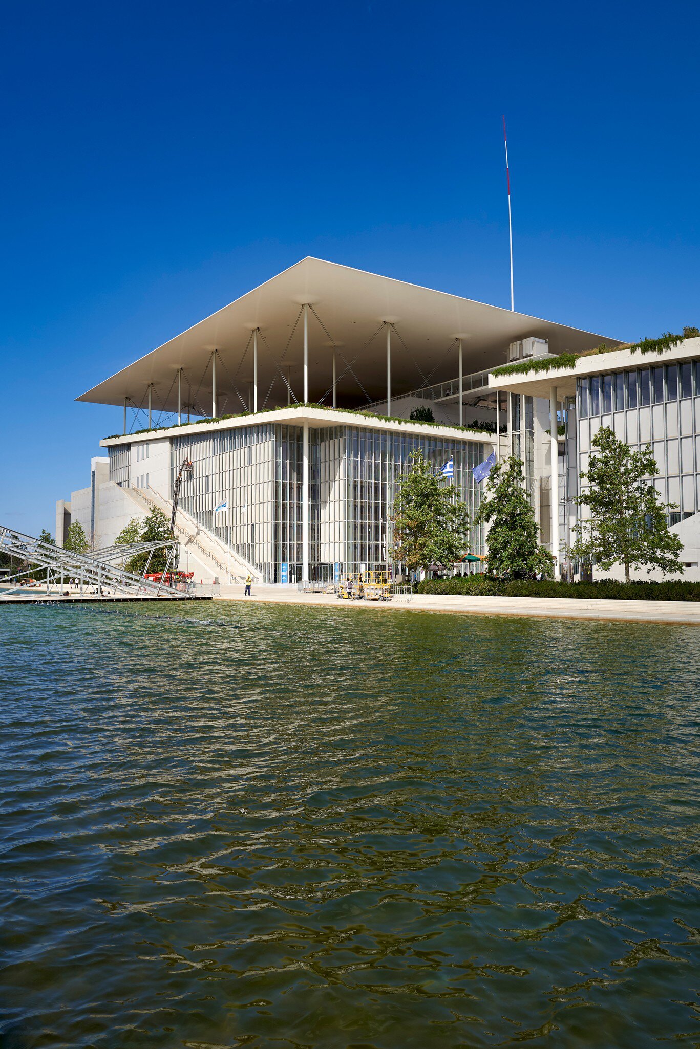View over the water of the Stavros Niarchos Foundation Cultural Center in Athens, Greece.