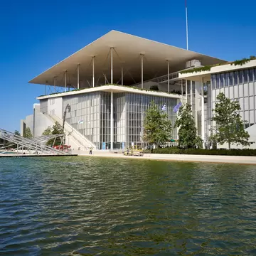 View over the water of the Stavros Niarchos Foundation Cultural Center in Athens, Greece.