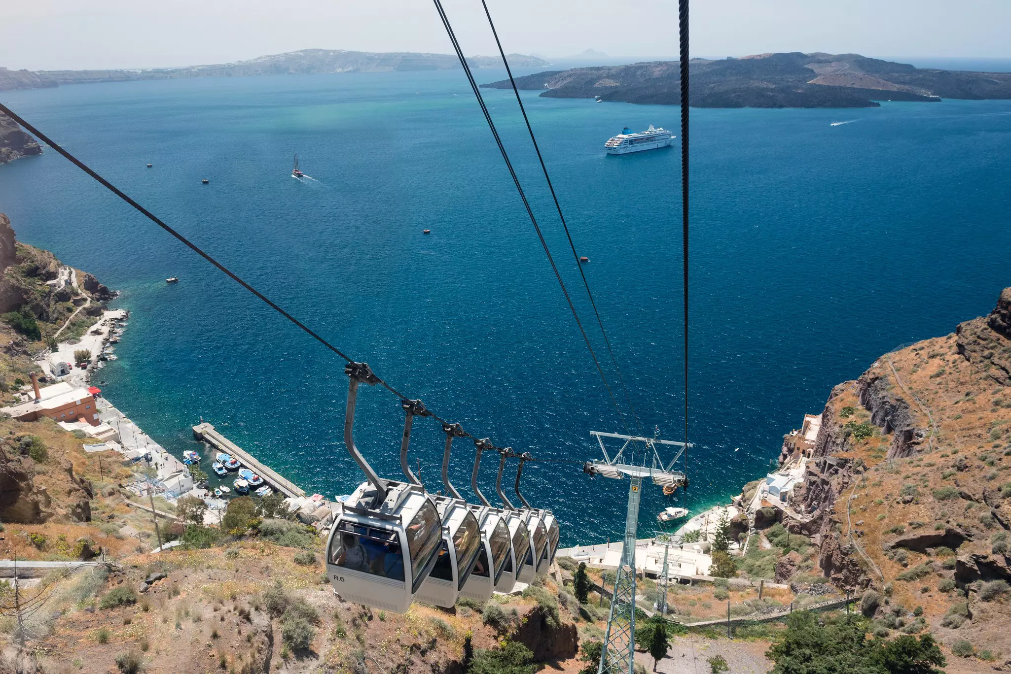 A cliffside cable car with a view of the sea at the bottom
