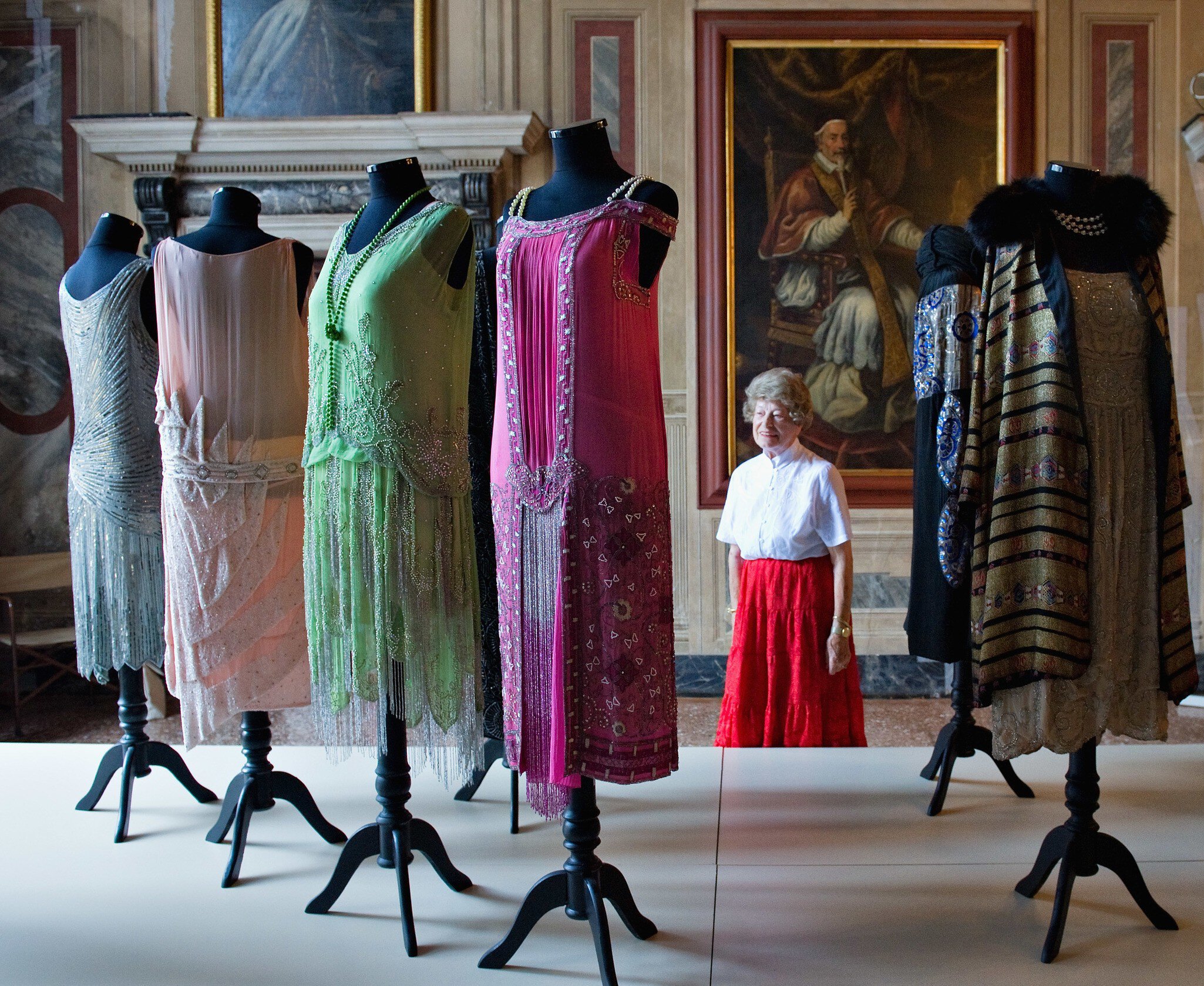 VENICE, ITALY - SEPTEMBER 16:  A woman admires some dresses  belonging to the collection of Alexander Vassiliev during the press preview of "Elegance in Exhile" at Palazzo Mocenigo on September 16, 2011 in Venice, Italy. "L'Eleganza in Esilio" tel...