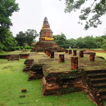 Wiang Kum Kam in Chiang Mai, Thailand. monument surrounded by greenery.