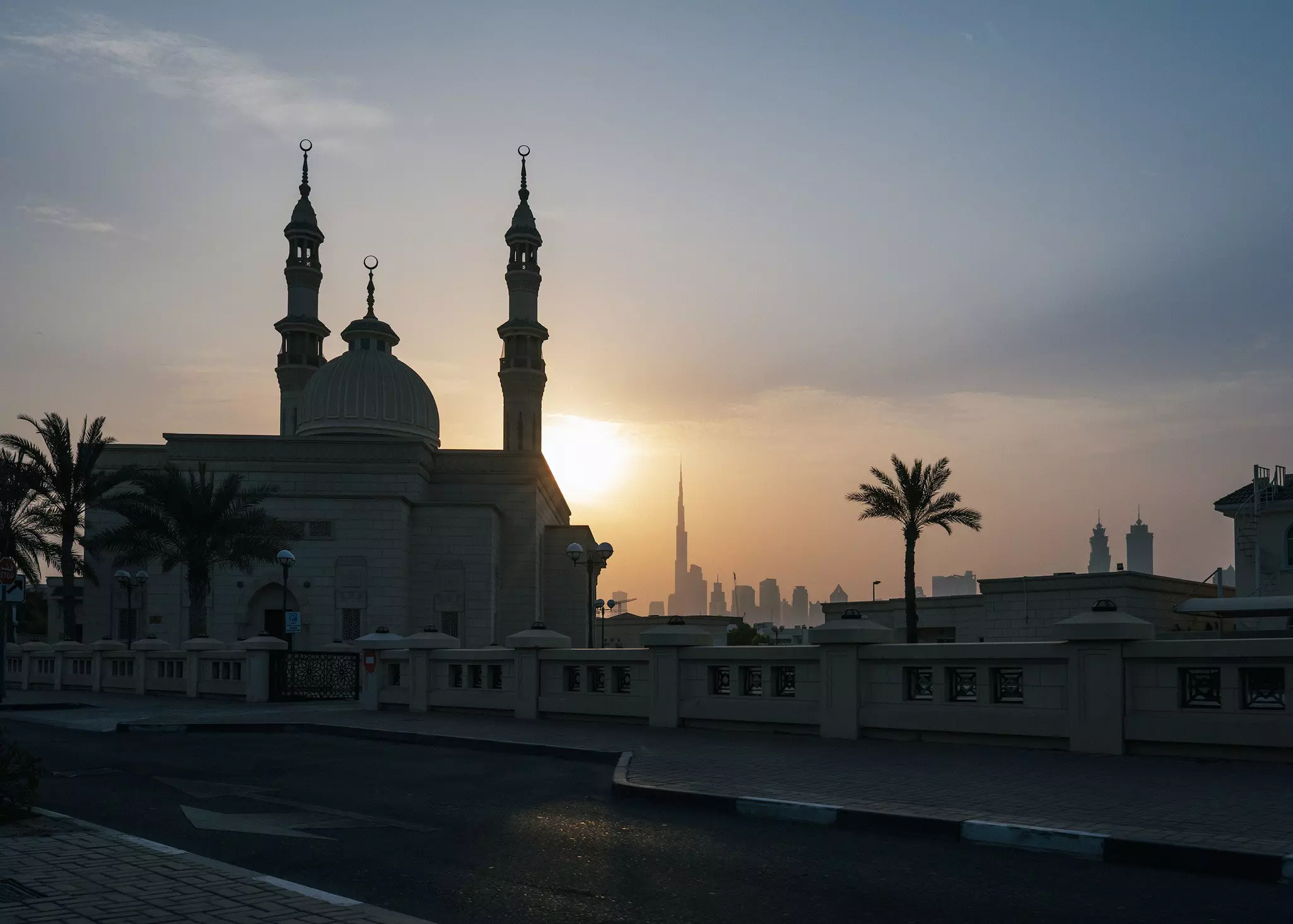The Dubai Skyline with a mosque in the foreground, at sunset. Eman Ali for Lonely Planet