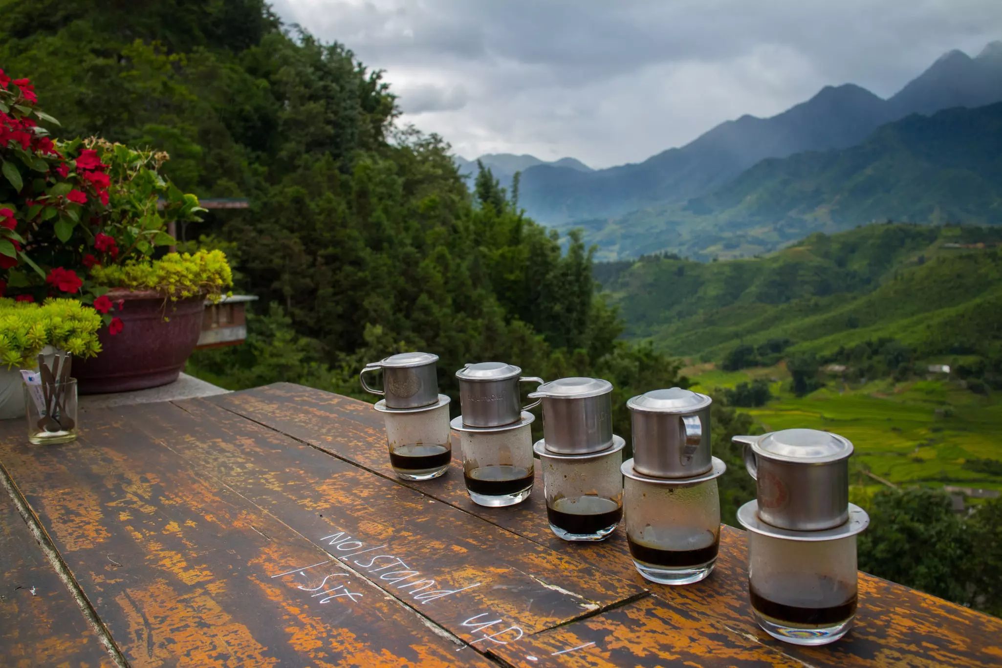 Vietnamese coffees line the bench top of a picturesque cafe.