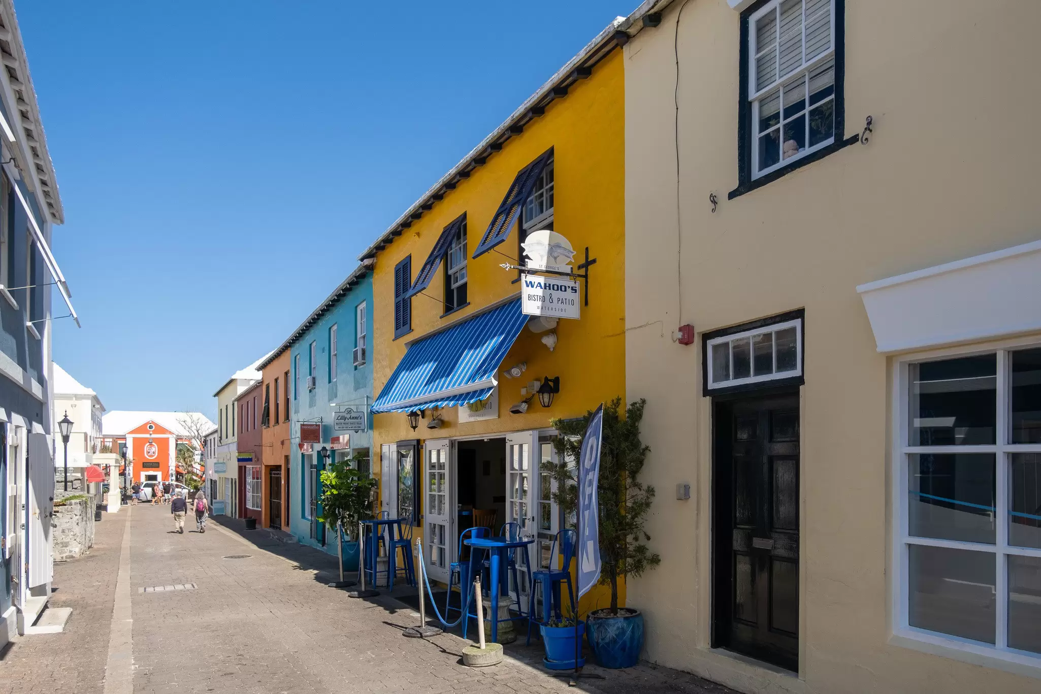Colorful shops and restaurants lining a narrow street in Bermuda