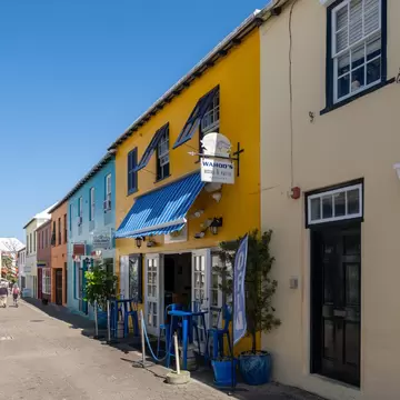 Colorful shops and restaurants lining a narrow street in Bermuda