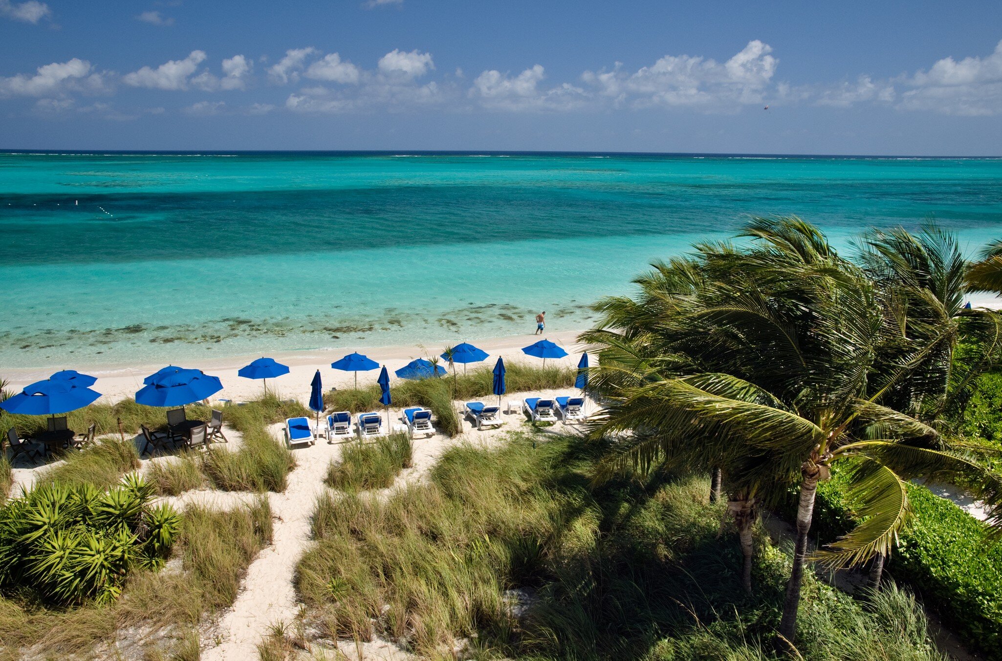 Umbrellas line the beachfront at Grace Bay Beach, Turks and Caicos. 