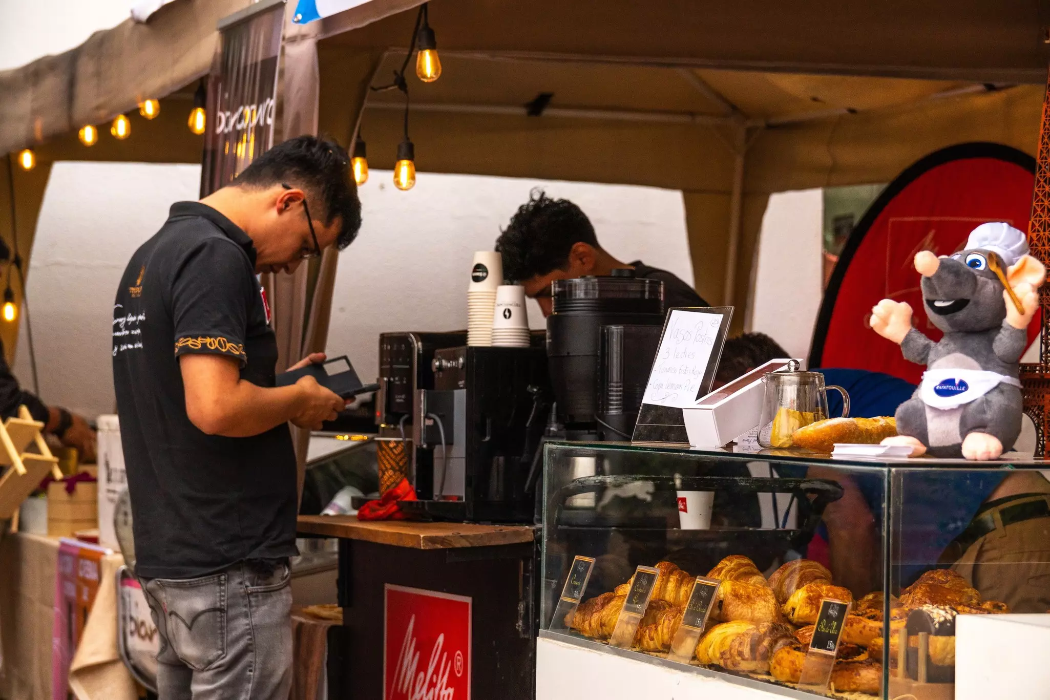 Cochabamba, Cochabamba, Bolivia; May, 3, 2024: Young man buying coffee from a small coffee shop on the street.