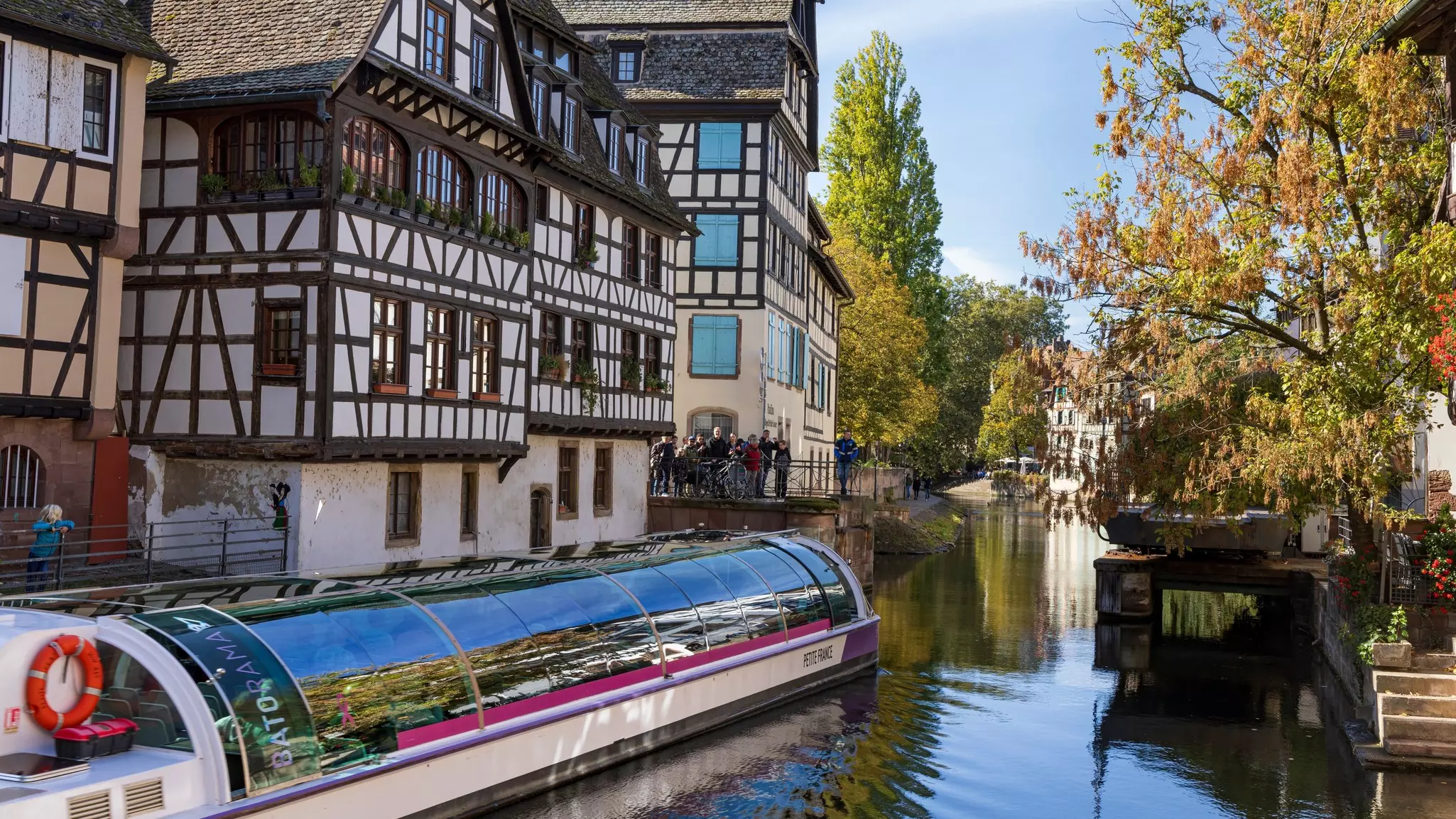 Cruise boat passing the locks in old town Petitit France of Strasbourg in Elsace region along the Rhine river in France