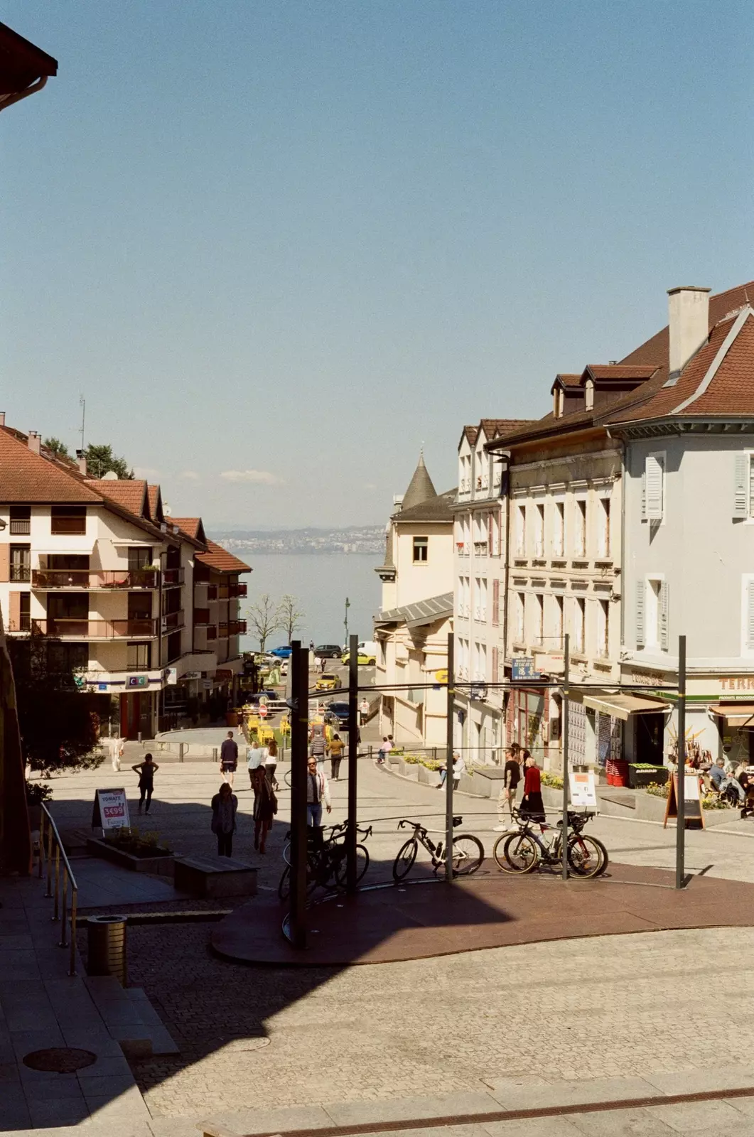 People walk around the place du marché (market square) in Évian-les-Bains, France