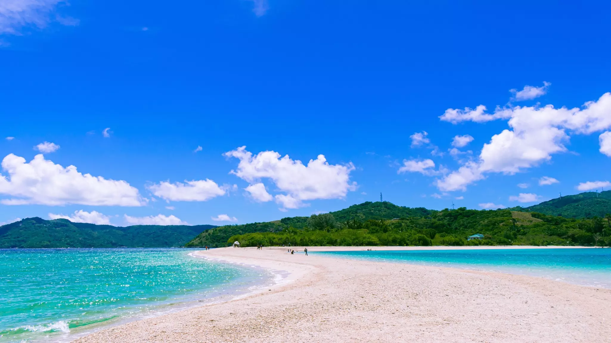 People walking along Bonbon Beach on Romblon Island, Philippines. 