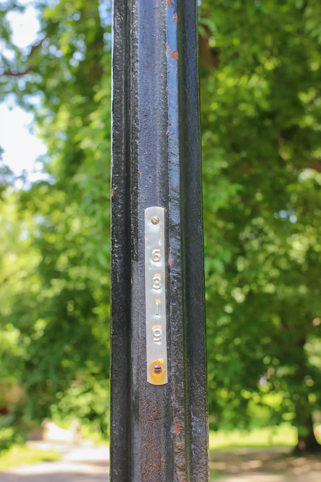 Numbers on a lamp post in Central Park, indicating which cross streets you're on
