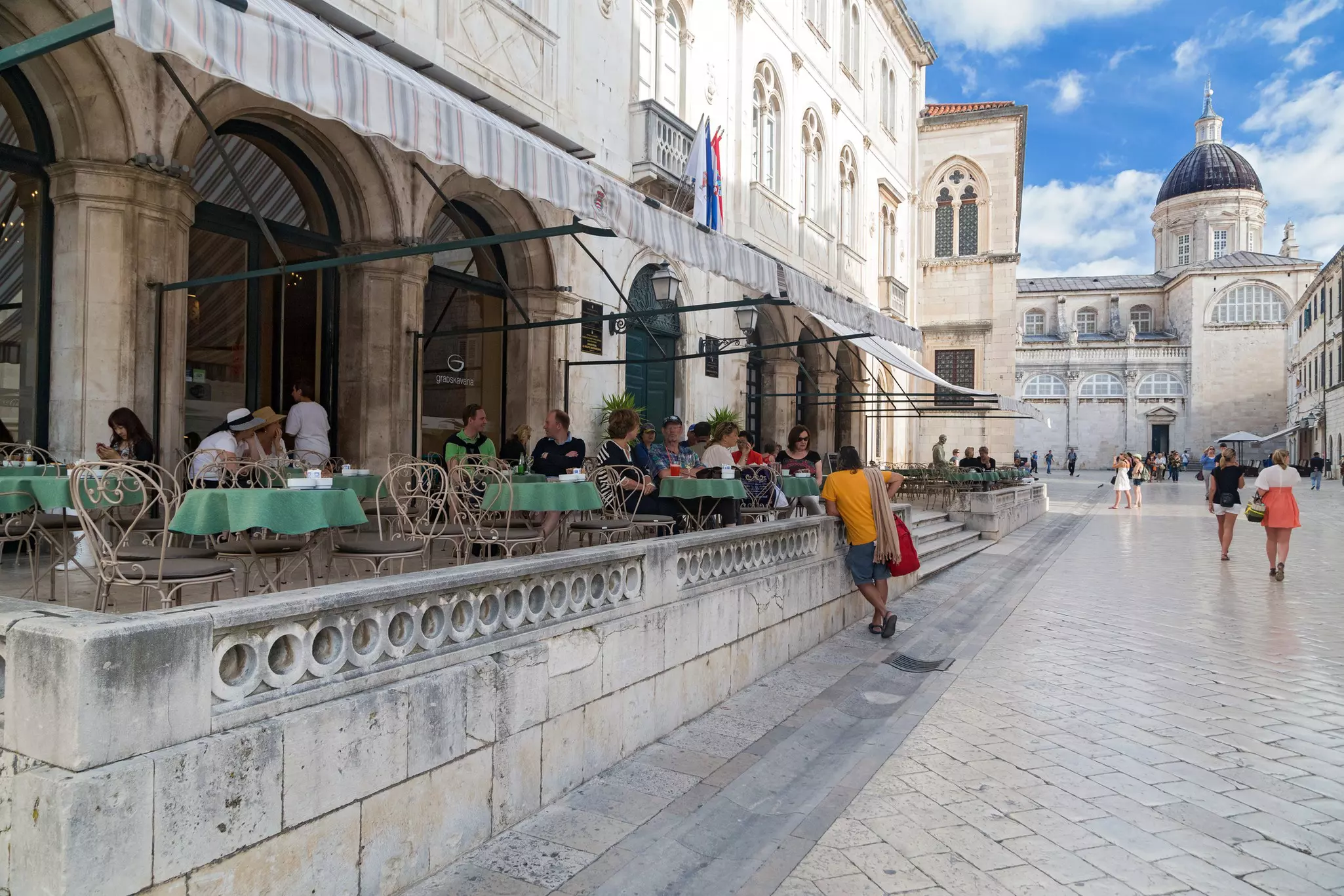 Guests sitting on the terrace of Gradska kavana cafe in Dubrovnik