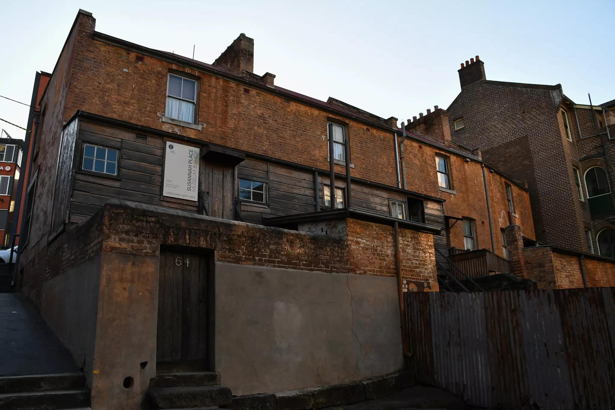An exterior shot of Susannah Place's main entrance of a small brown building make of wood and brick