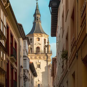View down an alley of the tower of the Catedral de Santa María in Vitoria, Spain.