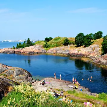 A sheltered bay with swimmers in the water.