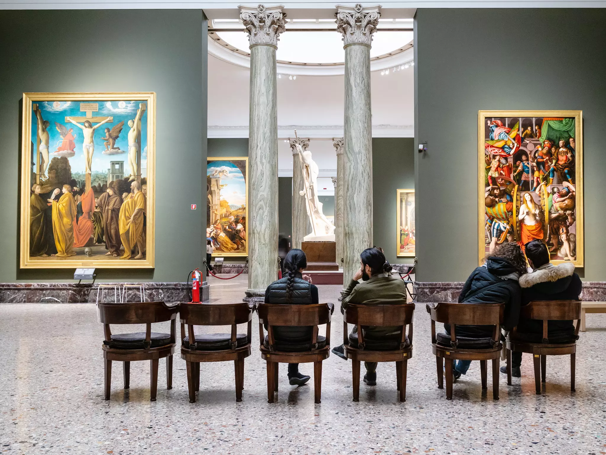 MILAN, ITALY - FEBRUARY 24, 2019: visitors sit in hall in Pinacoteca di Brera (Brera Art Gallery) in Milan. The Brera is national picture gallery of ancient and modern art in Palazzo Brera  License Type: media  Download Time: 2023-07-18T16:29:12.000Z  User: FergalCo  Is Editorial: Yes  purchase_order:   