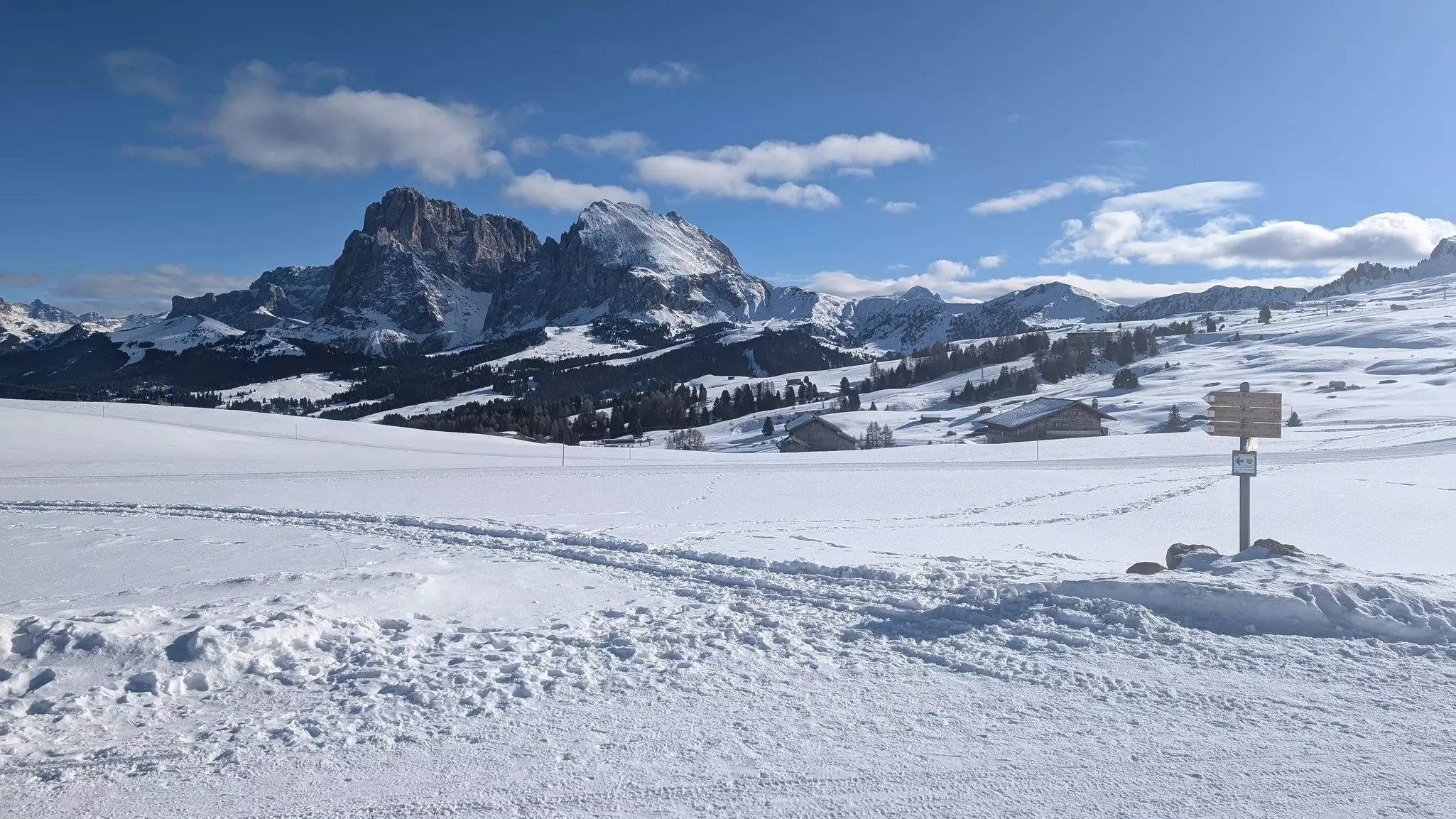 Landscape covered in snow with mountains in the background in Alpe de Siusi, Italy