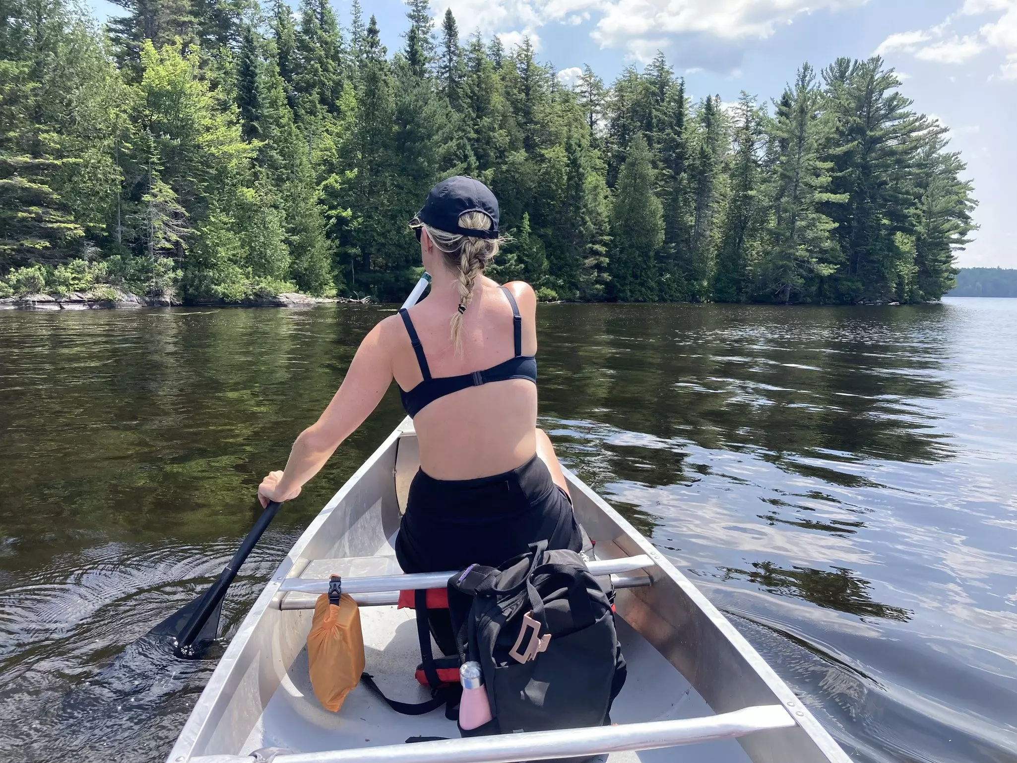Lonely Planet writer Isabella Noble canoes across a lake in Algonquin Provincial Park, Canada © Isabella Noble / Lonely Planet