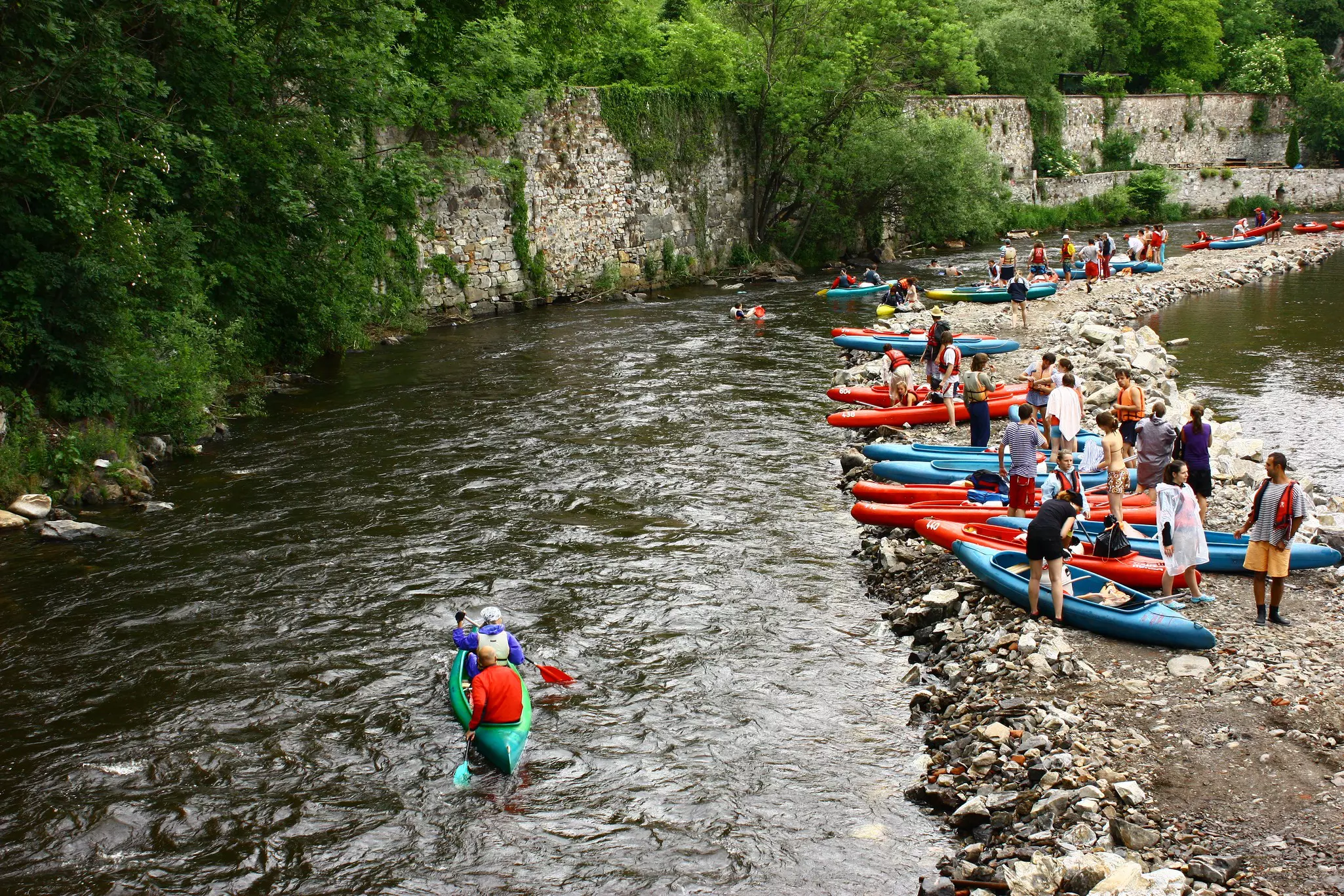 CESKY KRUMLOV, CZECH REPUBLIC - 28 May 2009. Young people are canoeing in the River Vltava.