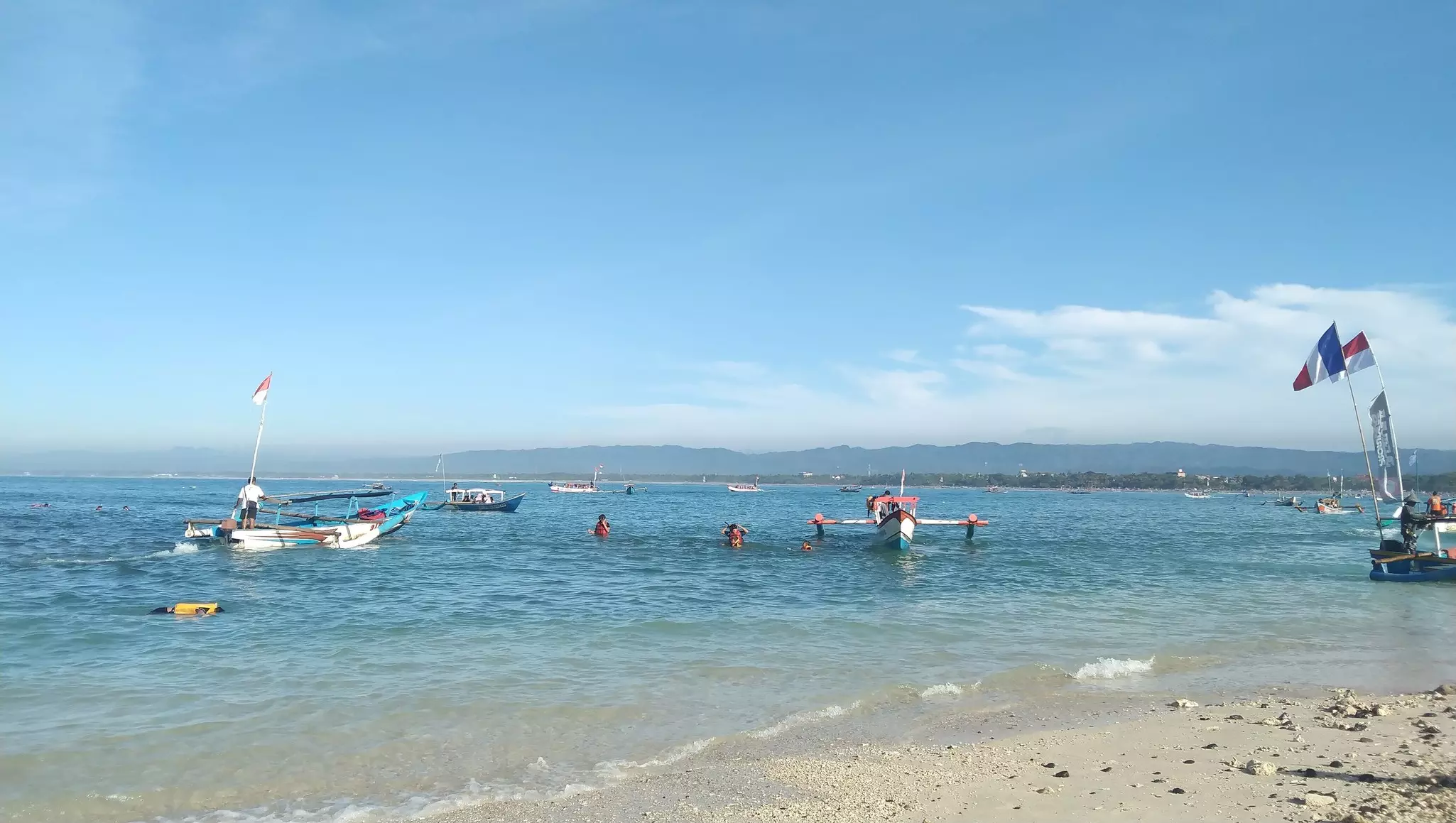 A fishing boat carrying tourists anchored at Pasir Putih beach.