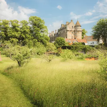 Historic Falkland Palace and village with landscaped gardens on a sunny summer day in Fife, Scotland, UK.