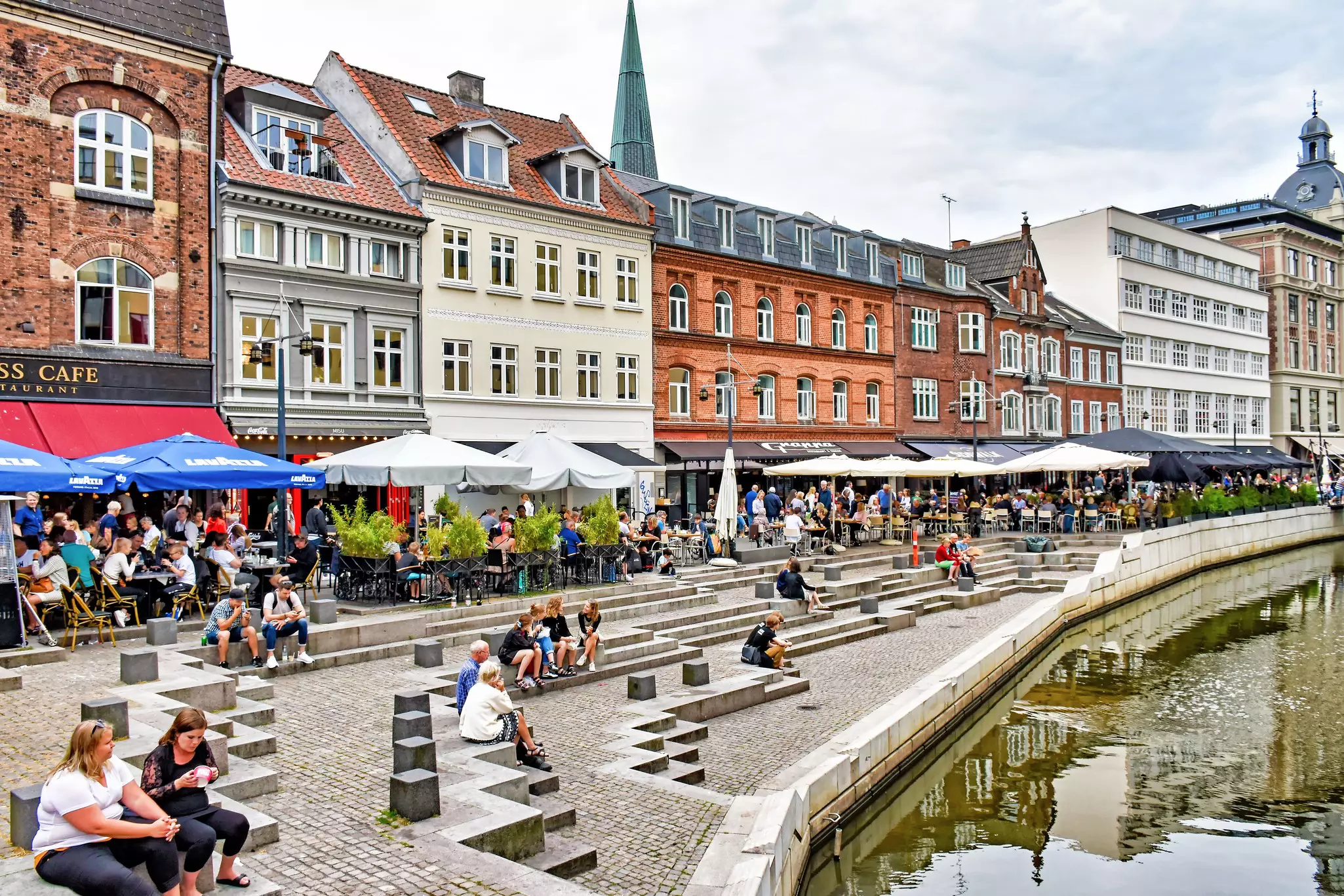 Many people enjoying the day at Aboulevardthe promenade along the river Aarhus