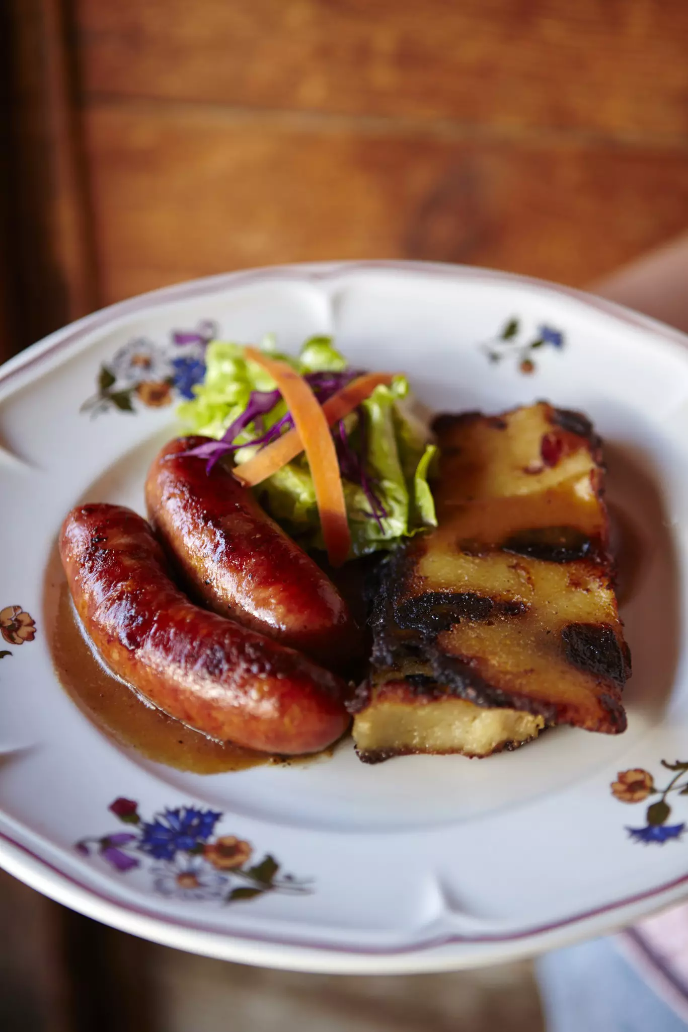 Traditional Savoyarde food - diot sausages with a slice of farçon at  restaurant Les Vieilles Luges.