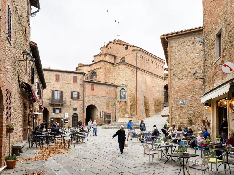 A shop and restaurant-lined street in Panicale