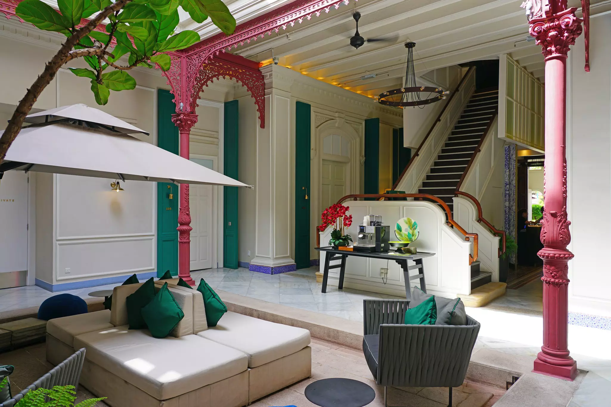 The lobby of a hotel in a renovated historic hotel shows columns and moldings.