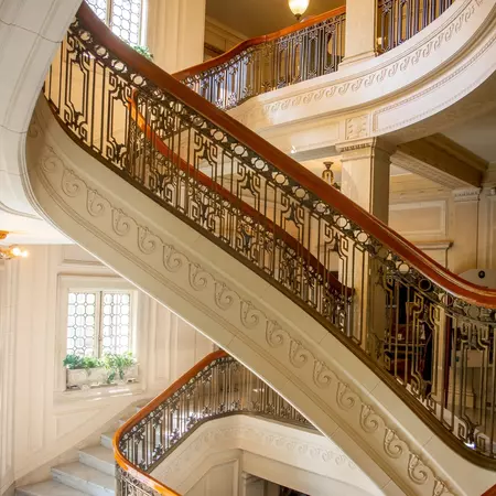 Rich grandeur staircase at Pittock Mansion, a French Renaissance-style historic chateau in the West Hills of Portland, Oregon, USA