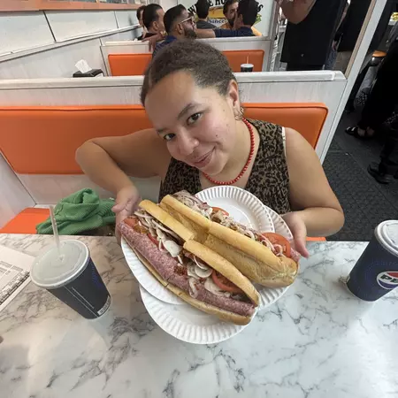 Chamidae Ford holding a sub sandwich at White House Subs.