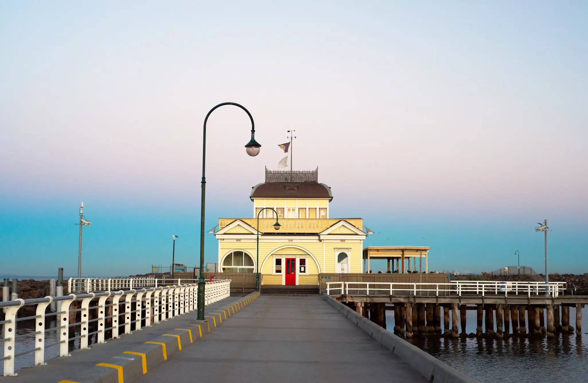 Yellow building on a pier with blue skies