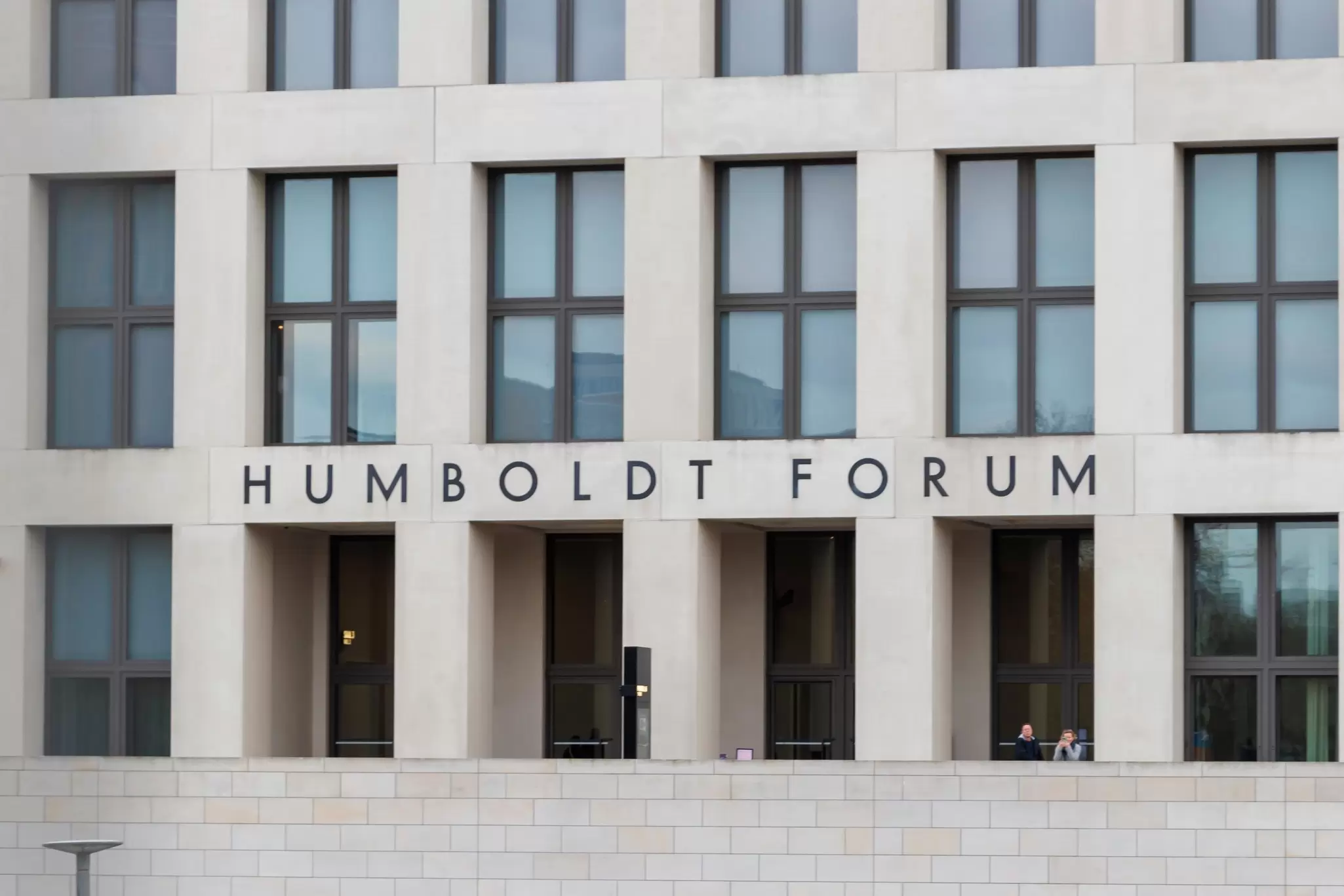 View of the modern Humboldt Forum building, showcasing its architectural design and large windows, in Berlin, Germany.