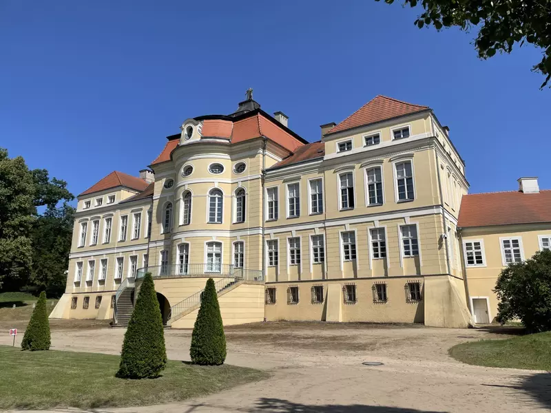 A large, yellow mansionlike building with many windows