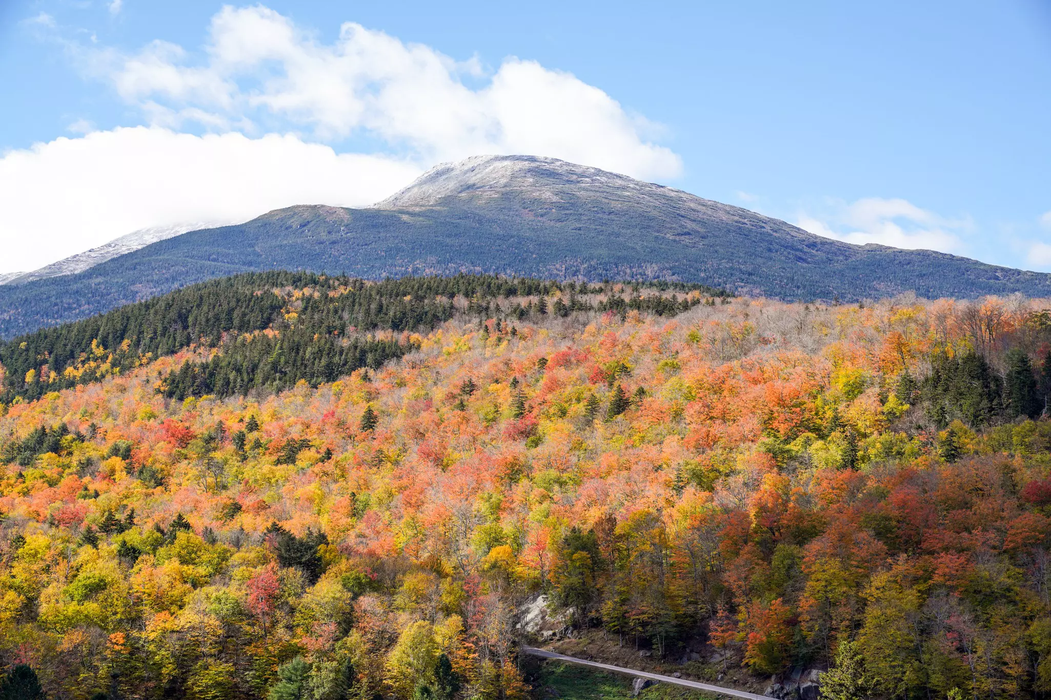 Fall foliage in the foreground leads to a mountain peak in New Hampshire.