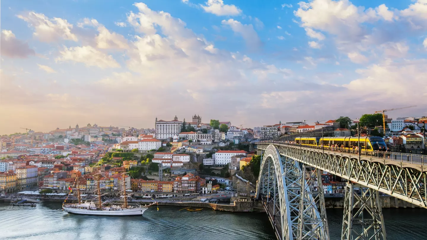 View of Porto city and the Douro River from the famous tourist viewpoint of Miradouro do Jardim do Morro during sunset.