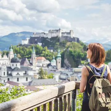 A lady is looking out at the view of Salzburg