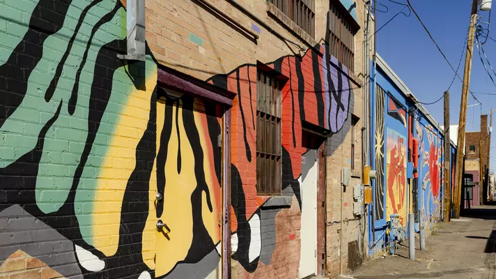 Murals line buildings on the streets